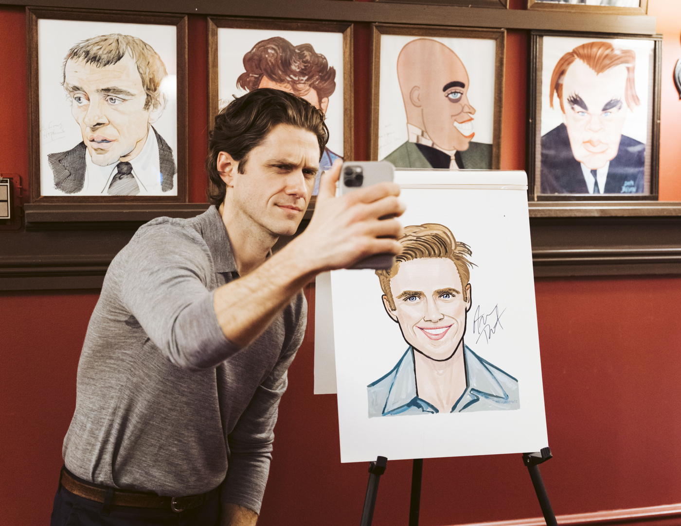 Aaron Tveit snaps a selfie with his Sardi's portrait. 
