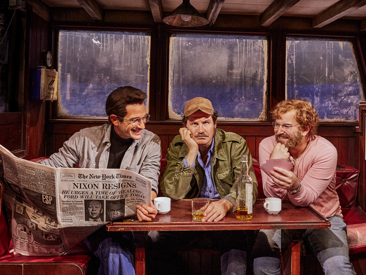 Colin Donnell, Ian Shaw and Alex Brightman sitting in a boat in The Shark is Broken