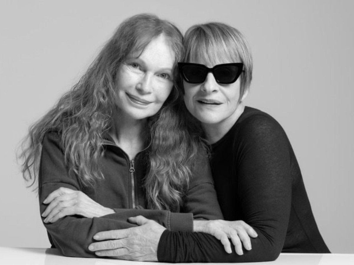 Mia Farrow and Patti LuPone side hug and smile