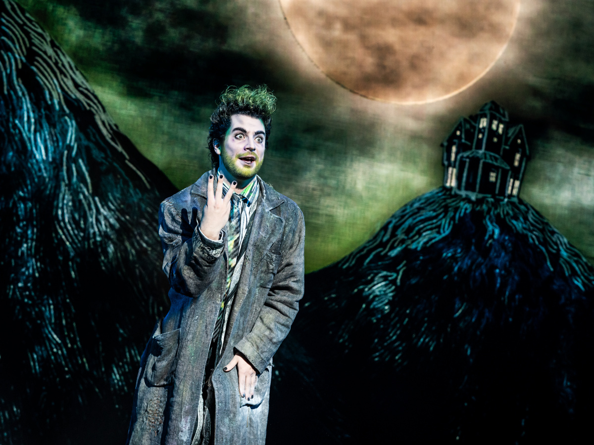 Beetlejuice stands in the spooky night 