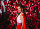Mean Girls lead Taylor Louderman looks as colorful as the flowers behind her. 