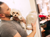 Hairdresser Kevin Thomas Garcia cuddles with Patrick Page’s dog Georgie.