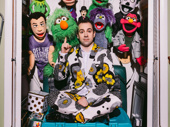 Rob McClure takes a seat among his puppet posse, which he houses in a room that contains all of his theater memorabilia.