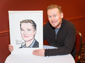 The Present star Richard Roxburgh poses with his Sardi's caricature after signing it.