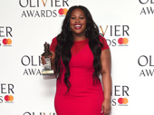 She's not goin'! Dreamgirls star Amber Riley strikes a pose with her Olivier Award for Best Actress in a Musical.(Photo: Getty Images)
