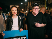 Olivia Wilde and Michael Moore take it all in.